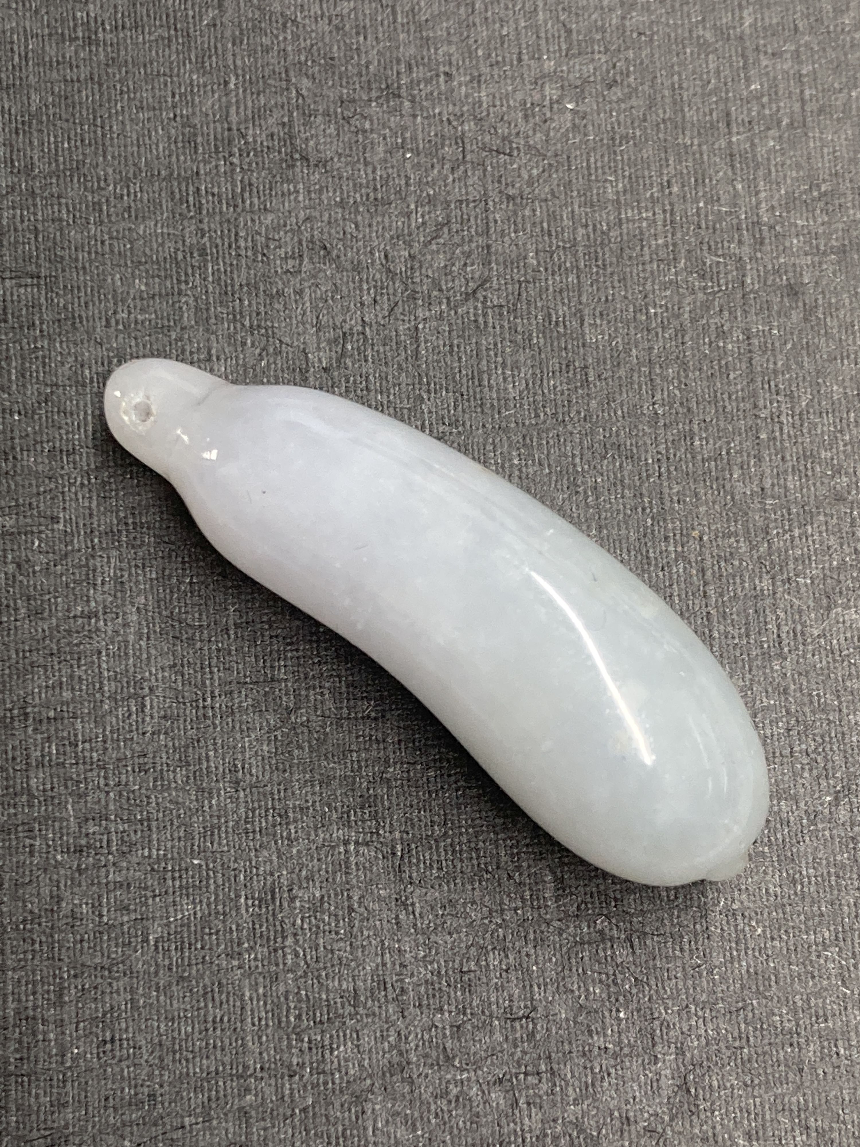 A Chinese jadeite gourd pendant, largest 43mm and two hardstone faux bamboo pendants.